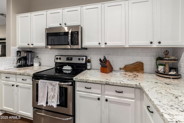 3532 W Mesquite Ave, San Tan Valley, AZ 85144 - kitchen featuring stainless steel appliances, white cabinets, and tasteful backsplash