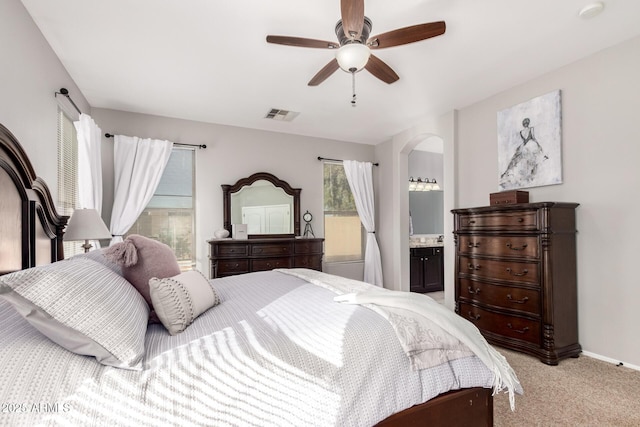 3532 W Mesquite Ave, San Tan Valley, AZ 85144 - bedroom featuring arched walkways, light colored carpet, ceiling fan, and connected bathroom