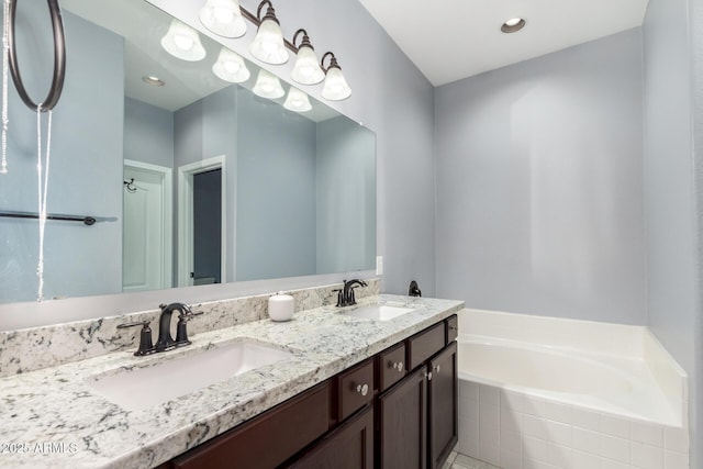 3532 W Mesquite Ave, San Tan Valley, AZ 85144 - bathroom with double vanity, a garden tub, and recessed lighting