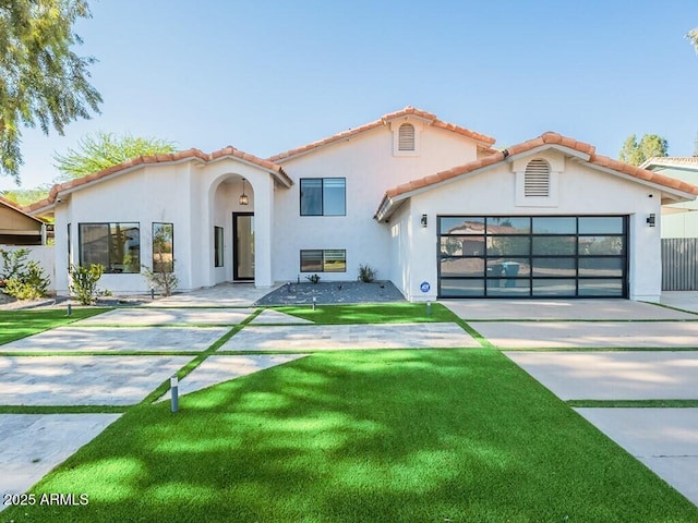 4748 E Redfield Rd, Phoenix, AZ 85032 - mediterranean / spanish-style house with concrete driveway, stucco siding, a garage, and a tiled roof