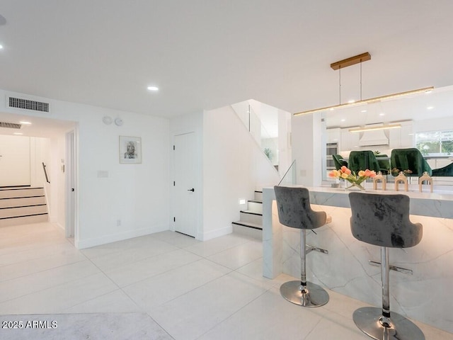 4748 E Redfield Rd, Phoenix, AZ 85032 - kitchen featuring light tile patterned floors, recessed lighting, hanging light fixtures, light countertops, and custom exhaust hood