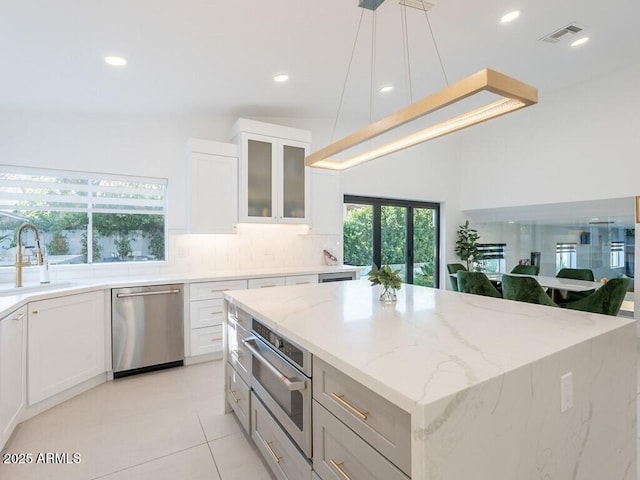 4748 E Redfield Rd, Phoenix, AZ 85032 - kitchen featuring a sink, appliances with stainless steel finishes, light stone counters, tasteful backsplash, and a center island