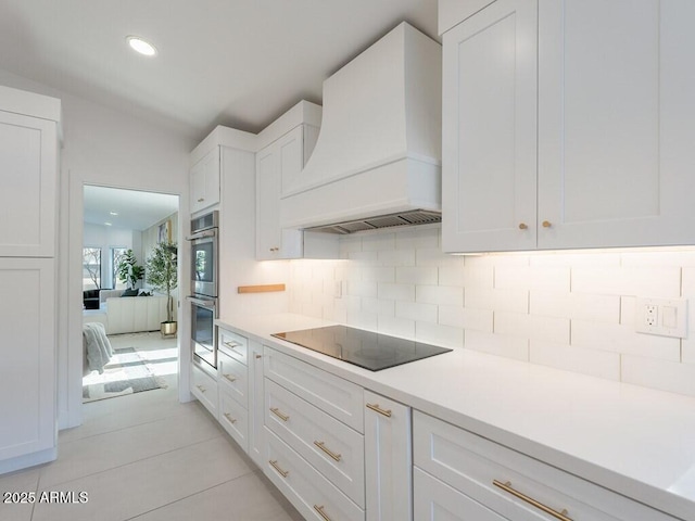 4748 E Redfield Rd, Phoenix, AZ 85032 - kitchen featuring custom range hood, black electric cooktop, white cabinets, double oven, and backsplash