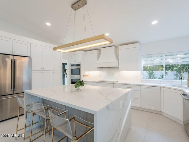 4748 E Redfield Rd, Phoenix, AZ 85032 - kitchen with stainless steel appliances, premium range hood, a sink, a center island, and white cabinets