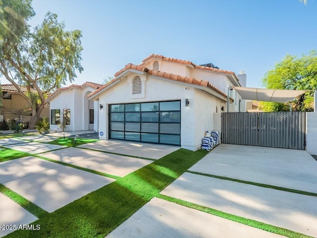 4748 E Redfield Rd, Phoenix, AZ 85032 - mediterranean / spanish-style house featuring concrete driveway, a gate, stucco siding, a garage, and a tile roof