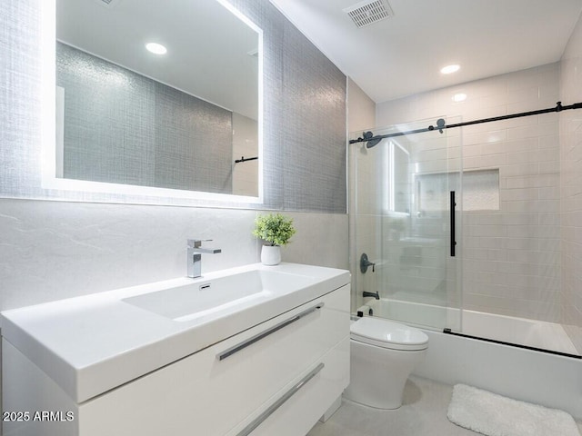 4748 E Redfield Rd, Phoenix, AZ 85032 - bathroom with combined bath / shower with glass door, toilet, vanity, recessed lighting, and tile walls