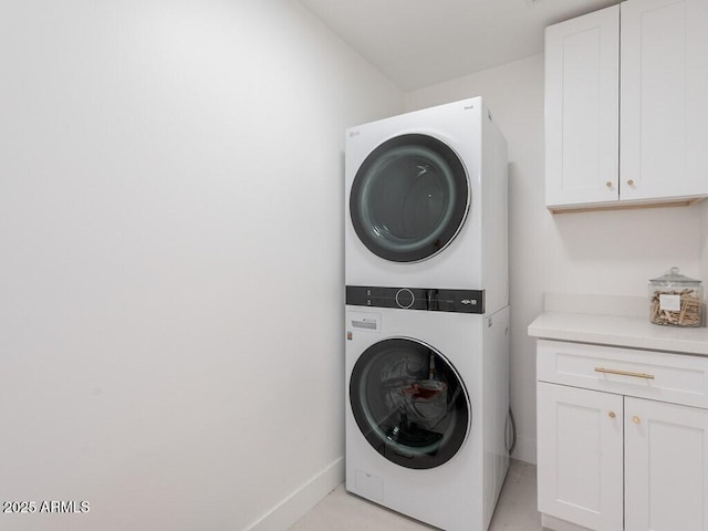 4748 E Redfield Rd, Phoenix, AZ 85032 - washroom featuring stacked washer / dryer, cabinet space, and baseboards