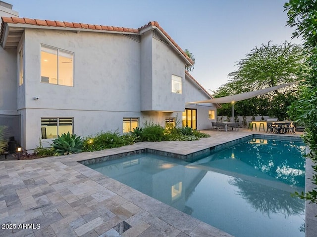 4748 E Redfield Rd, Phoenix, AZ 85032 - pool at dusk featuring outdoor dining area, an outdoor pool, and a patio