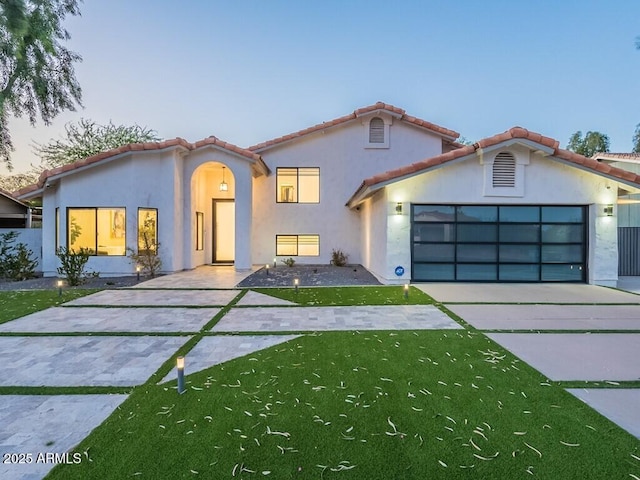 4748 E Redfield Rd, Phoenix, AZ 85032 - mediterranean / spanish-style house with concrete driveway, a garage, a tile roof, and a front lawn