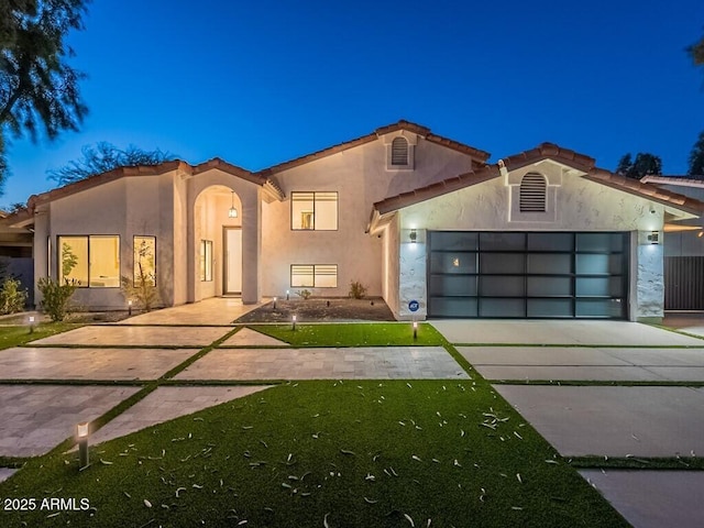 4748 E Redfield Rd, Phoenix, AZ 85032 - mediterranean / spanish-style house featuring concrete driveway, stucco siding, a garage, and a tile roof