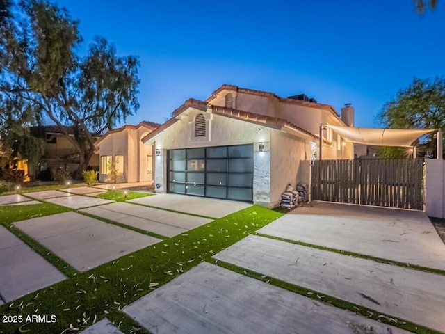 4748 E Redfield Rd, Phoenix, AZ 85032 - mediterranean / spanish house with driveway, stucco siding, a chimney, and a garage