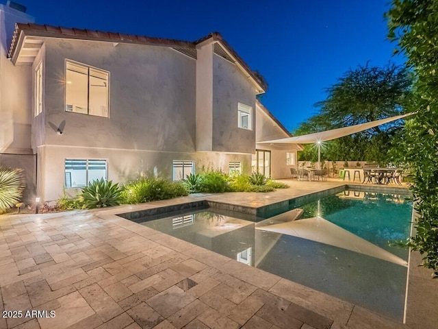 4748 E Redfield Rd, Phoenix, AZ 85032 - pool at night featuring a patio and an outdoor pool