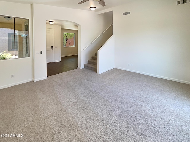 carpeted empty room featuring ceiling fan