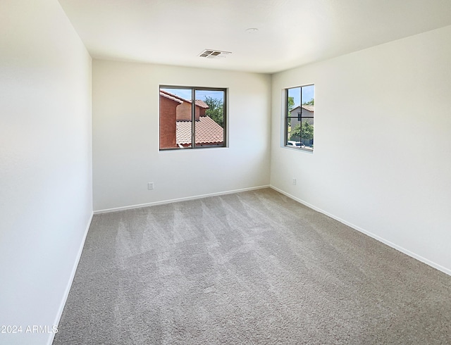 unfurnished room featuring carpet