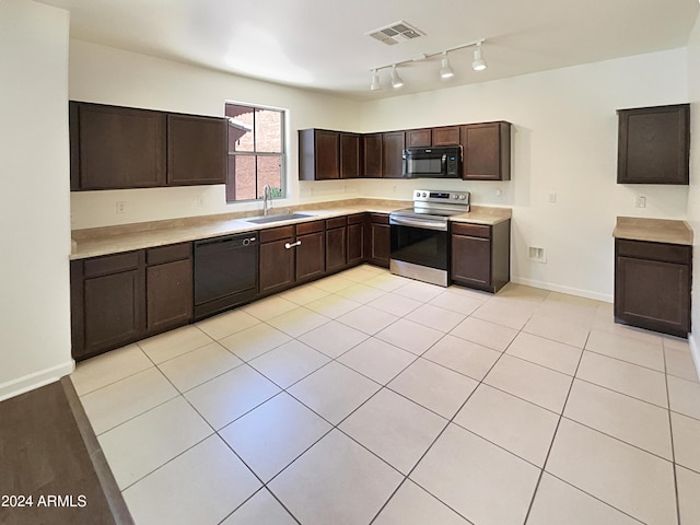 kitchen with sink, light tile patterned floors, black appliances, and dark brown cabinets