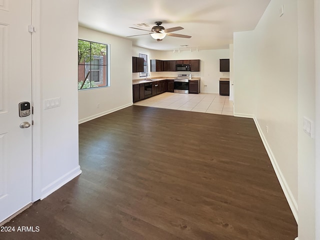 unfurnished living room with light hardwood / wood-style floors, ceiling fan, and sink