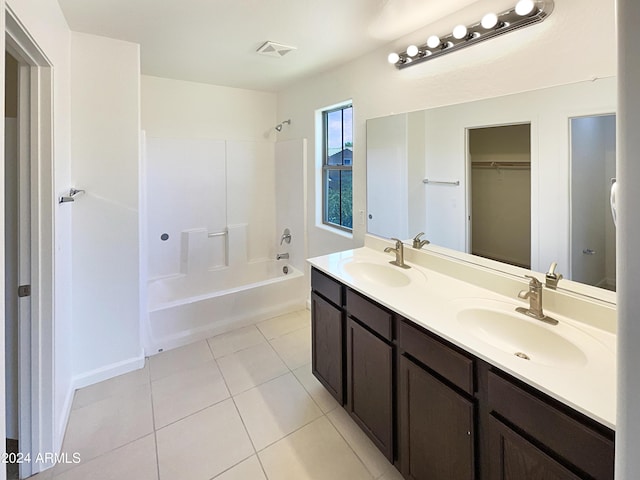 bathroom featuring tile patterned flooring, shower / tub combination, and vanity