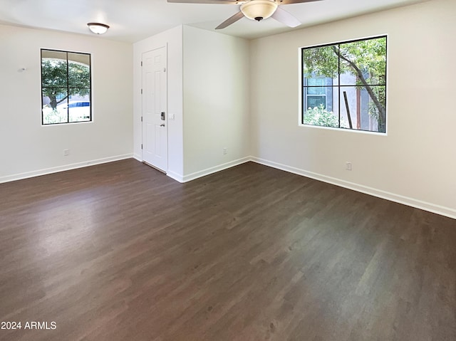 spare room featuring ceiling fan and dark wood-type flooring