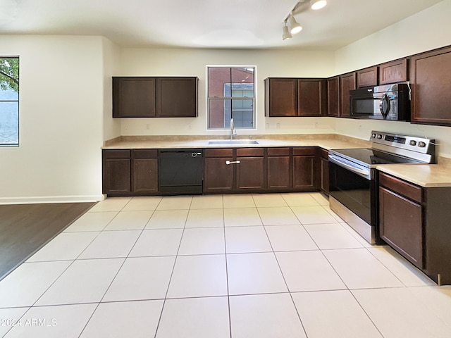 kitchen featuring sink, rail lighting, dark brown cabinets, light tile patterned flooring, and black appliances