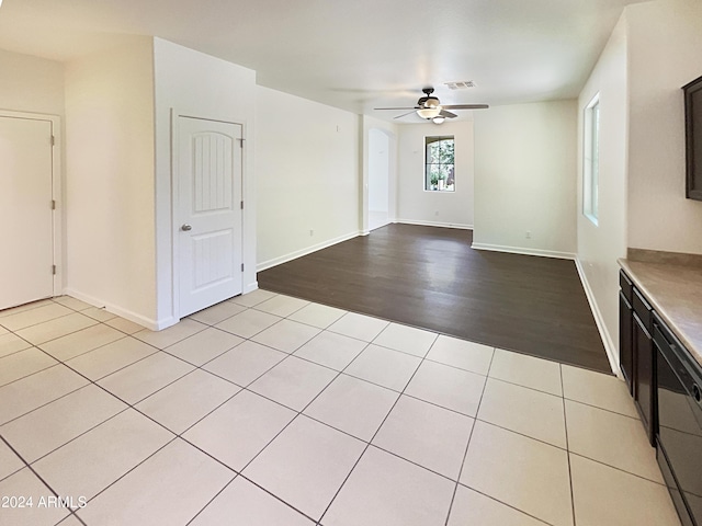 unfurnished living room with light wood-type flooring and ceiling fan