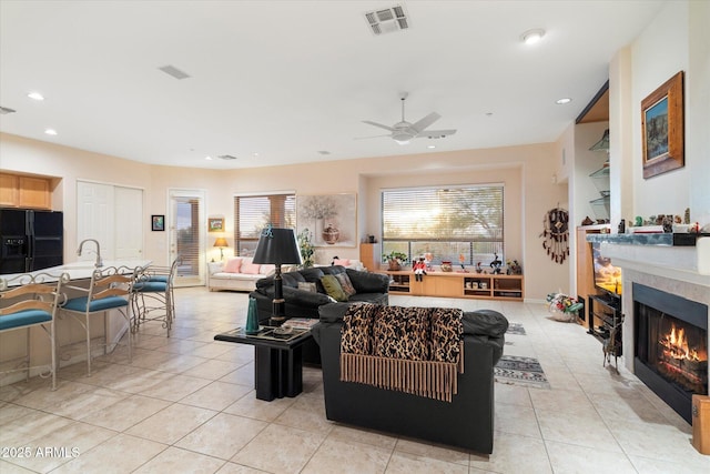 living area featuring visible vents, recessed lighting, light tile patterned floors, ceiling fan, and a tile fireplace