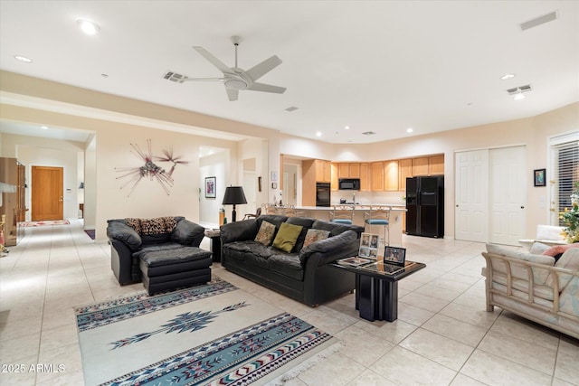 living room featuring light tile patterned floors, recessed lighting, and visible vents