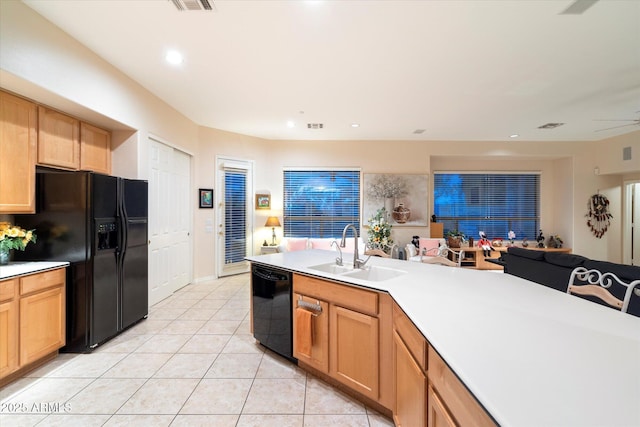 kitchen featuring black appliances, a sink, recessed lighting, light countertops, and light tile patterned floors