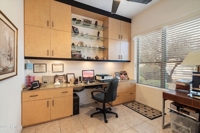 office space with light tile patterned flooring and built in desk