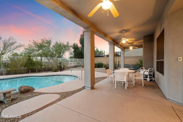 view of swimming pool featuring outdoor dining space, a ceiling fan, a patio, a fenced backyard, and a fenced in pool