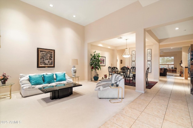 tiled living room featuring visible vents, recessed lighting, and baseboards