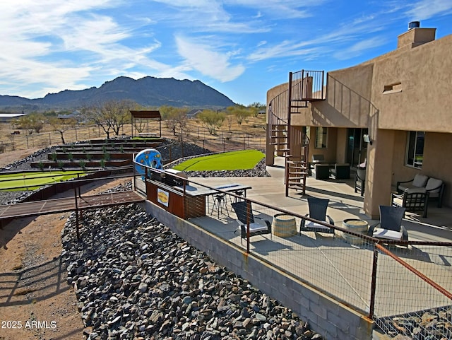 exterior space with stairway, fence, and a mountain view