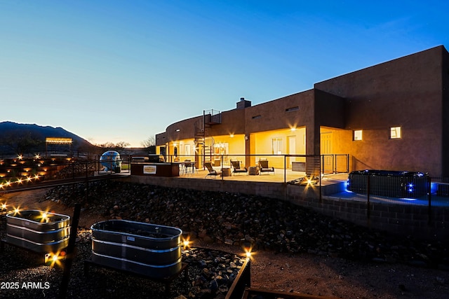 exterior space with an outdoor fire pit, a chimney, and a patio area