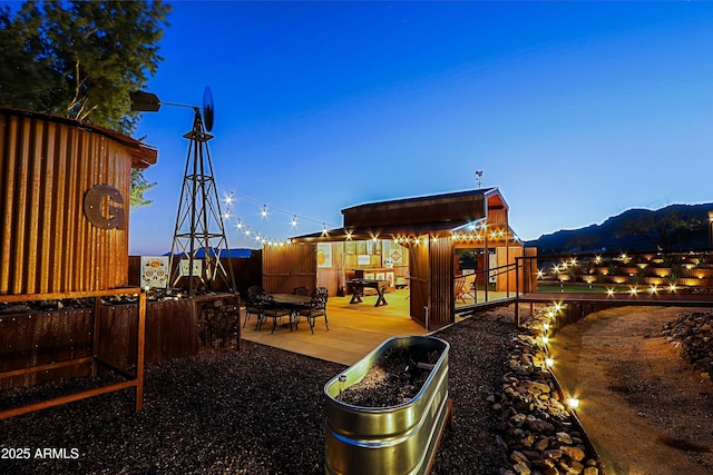 exterior space with a patio, an outdoor structure, and fence