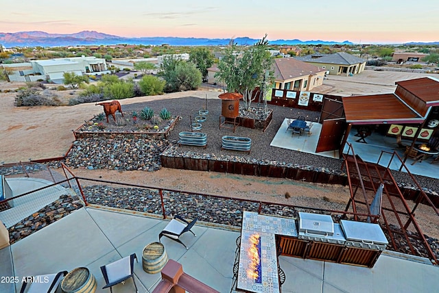 aerial view at dusk featuring a mountain view