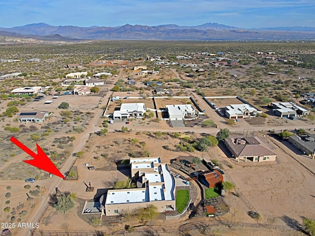 birds eye view of property featuring a mountain view