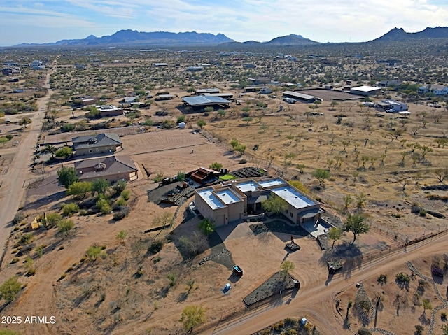 birds eye view of property featuring view of desert and a mountain view