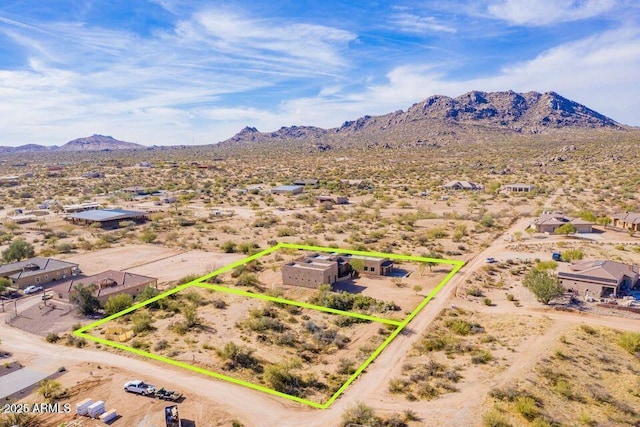 drone / aerial view featuring a mountain view and a desert view