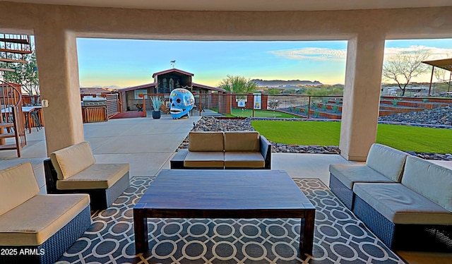 view of patio / terrace featuring an outdoor living space and fence