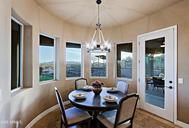 dining room with a notable chandelier and baseboards