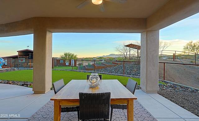 view of patio featuring outdoor dining space and fence