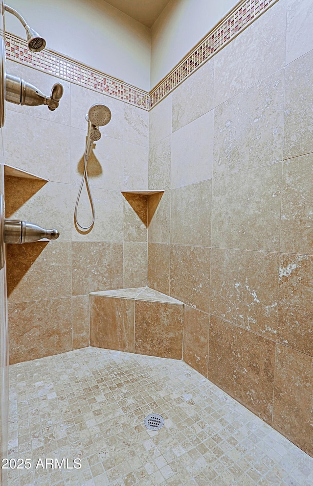 bathroom with tiled shower