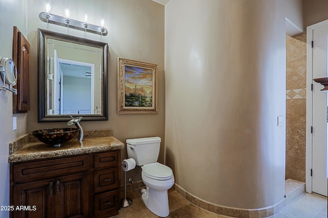 full bathroom with a shower stall, toilet, vanity, and baseboards