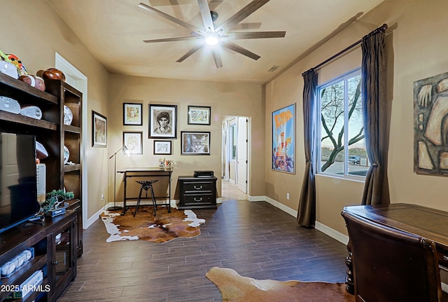 living area with baseboards, wood finished floors, visible vents, and ceiling fan