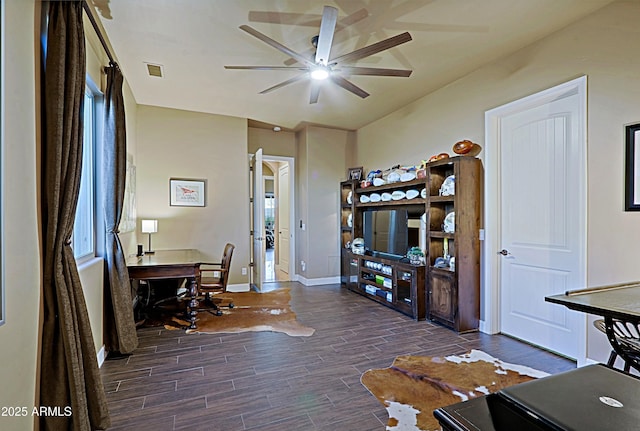 home office featuring baseboards, a ceiling fan, visible vents, and wood tiled floor