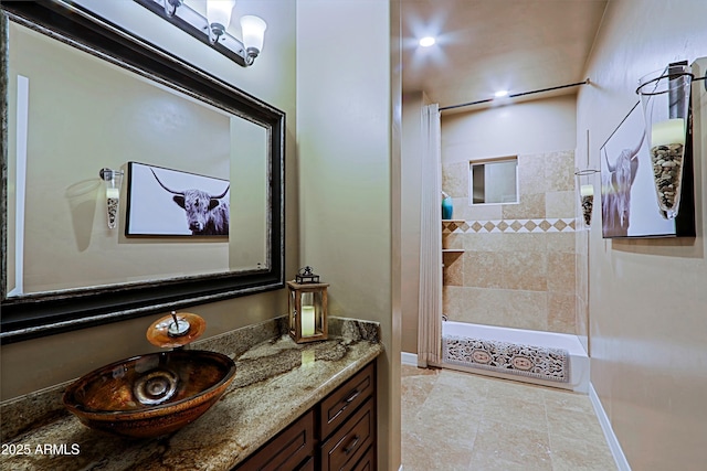 full bathroom featuring baseboards and vanity