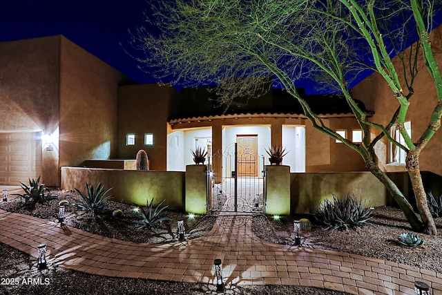 view of front of home featuring a fenced front yard and a gate