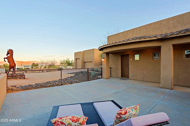 view of patio terrace at dusk