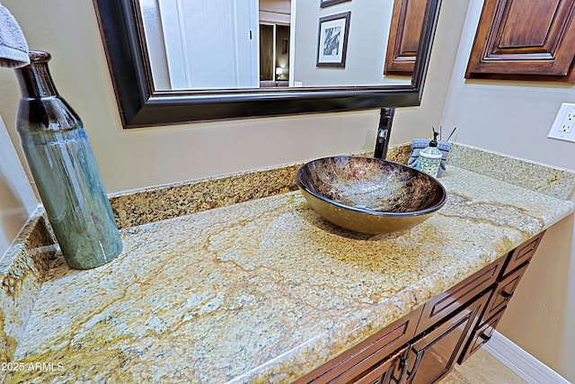 bathroom with vanity and baseboards