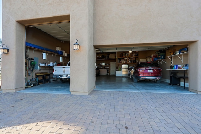 garage featuring decorative driveway