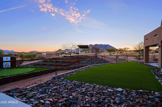 view of yard with a mountain view and fence